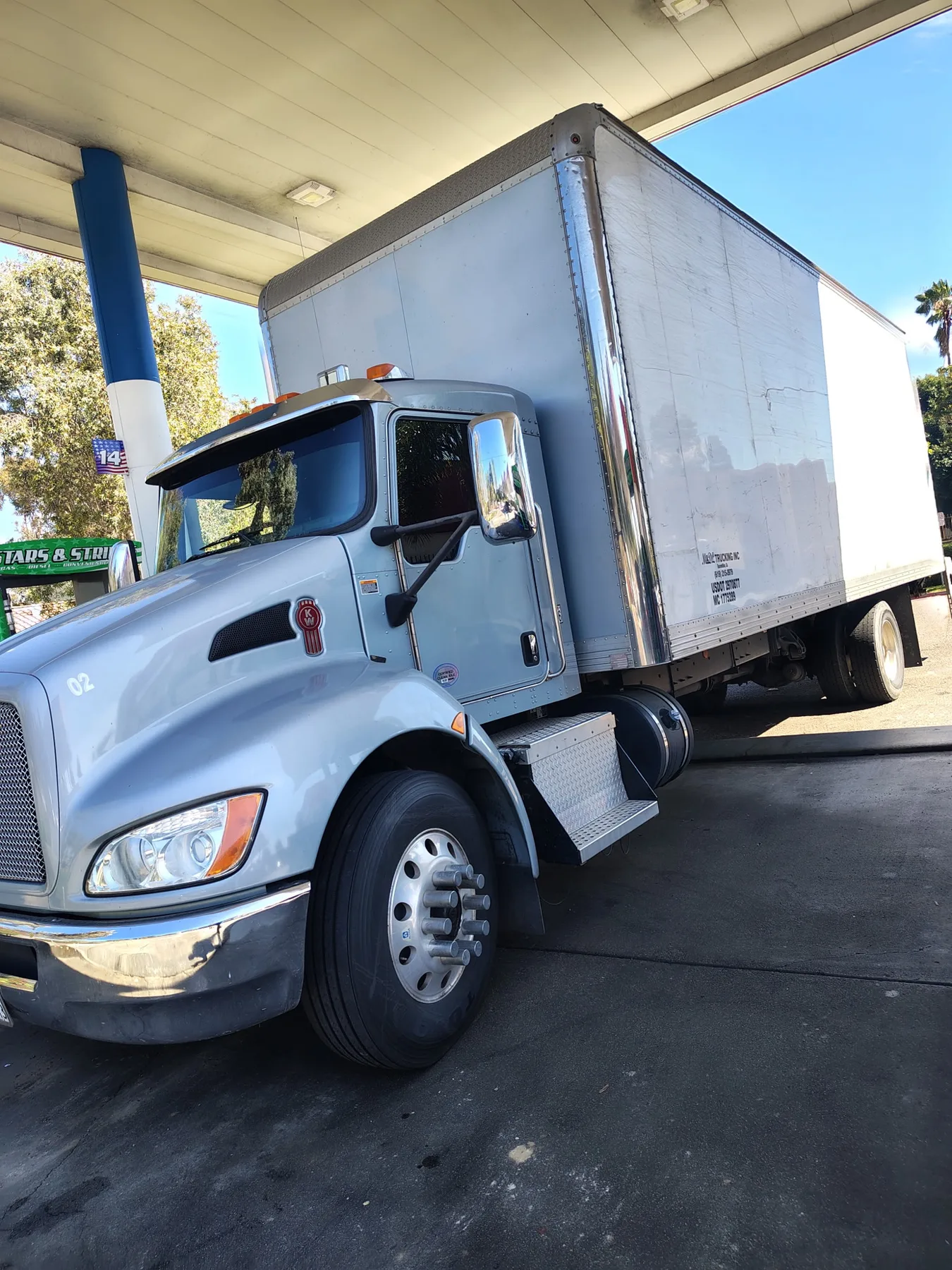 Twenty-six foot box truck parked at a fuel station